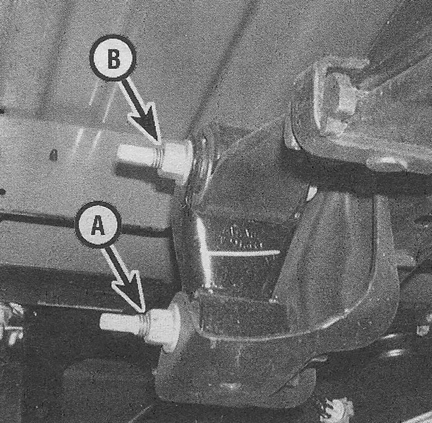 Chevrolet Silverado Suspension and steering systems _ At the rear end of the spring, remove the spring shackle-to-frame nut and bolt (A); the shackle-to-spring nut and bolt (B) can't be removed until the spring and shackle are removed from the vehicle