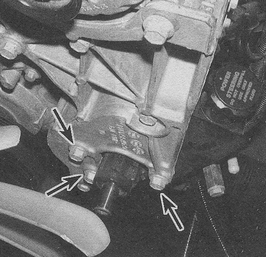 Chevrolet Silverado Suspension and steering systems _ Pump bolt locations (three bolts are only accessible with pulley off; the other one is shown by the arrow located on the back side of the pump mounting plate)