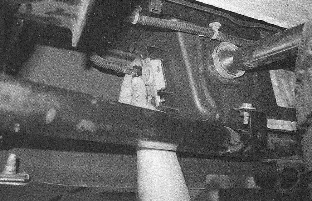 Chevrolet Silverado Chassis electrical system _ Bulb replacement _ Carefully twist the license plate light housing out of the bumper (photo is taken from under the truck looking at the backside of the rear bumper)